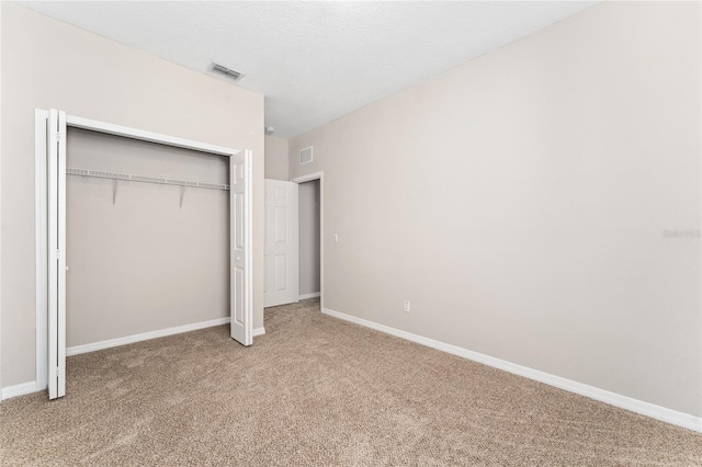 unfurnished bedroom featuring a closet and carpet