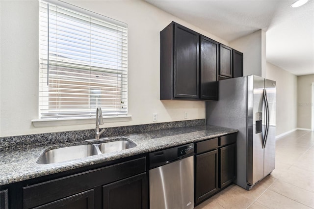 kitchen featuring sink, light tile patterned flooring, and appliances with stainless steel finishes