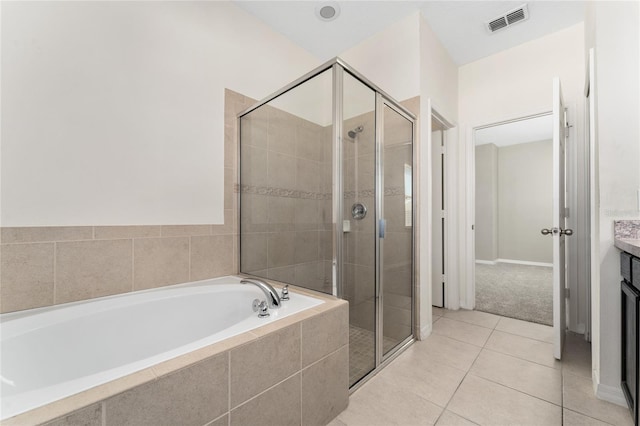 bathroom with tile patterned floors, vanity, and independent shower and bath