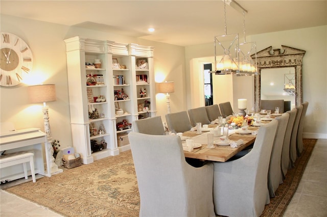 dining space featuring tile patterned flooring and a chandelier