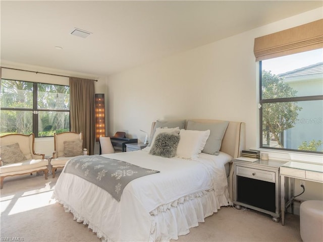 bedroom featuring light carpet