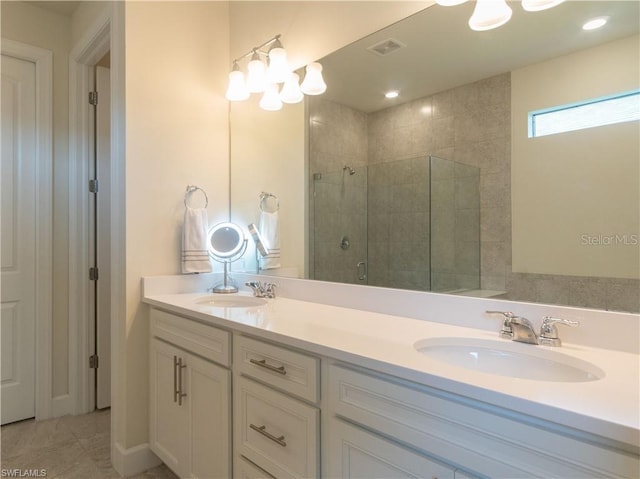 bathroom with tile patterned flooring, vanity, and walk in shower