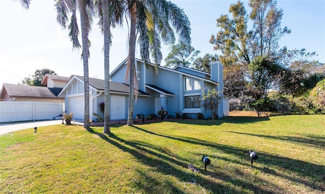 view of front of home with a front yard and a garage