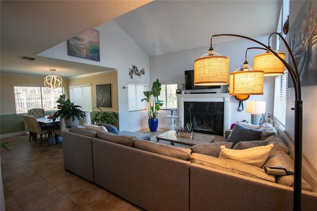 living room with a fireplace, tile patterned flooring, crown molding, and lofted ceiling