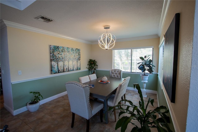 dining space with a chandelier, a textured ceiling, and crown molding