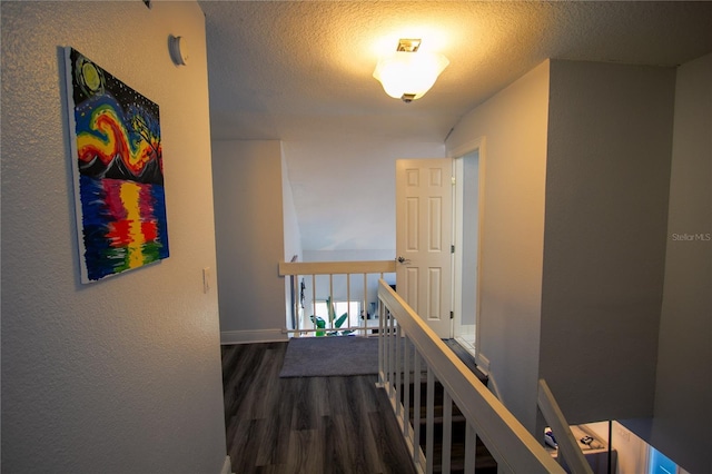 corridor featuring a textured ceiling and hardwood / wood-style flooring