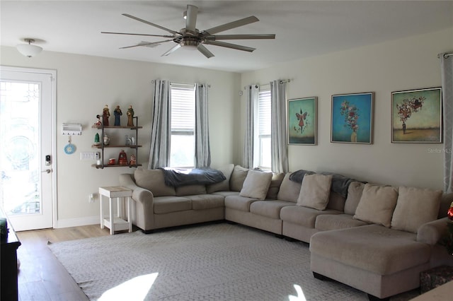 living room with ceiling fan and light hardwood / wood-style flooring