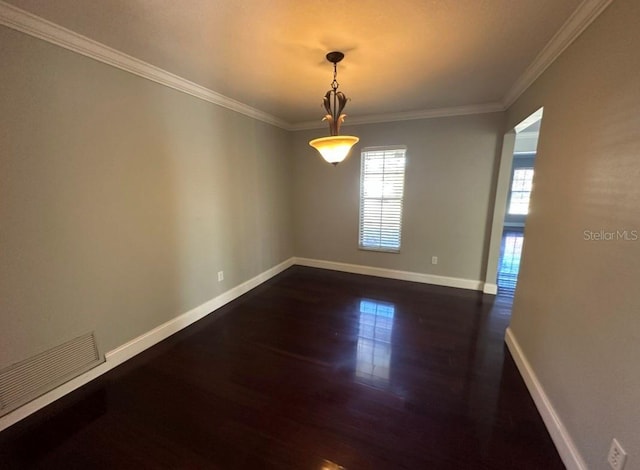 empty room featuring dark hardwood / wood-style floors and ornamental molding