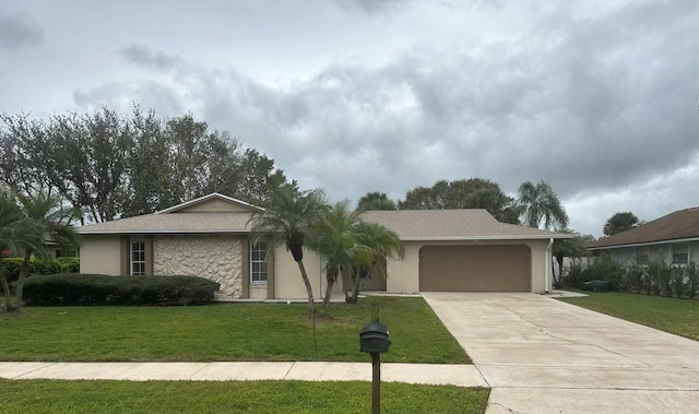 single story home featuring stone siding, driveway, a front lawn, and an attached garage