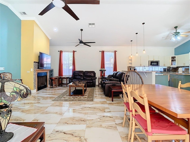 dining room featuring plenty of natural light and crown molding