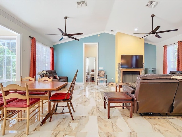 dining space featuring a healthy amount of sunlight, crown molding, ceiling fan, and lofted ceiling