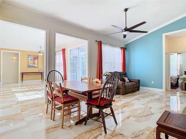 dining space featuring ceiling fan, lofted ceiling, and ornamental molding