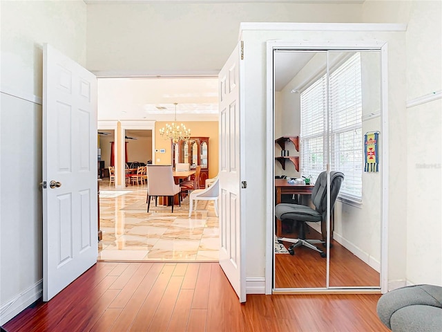 office space with a notable chandelier and wood-type flooring