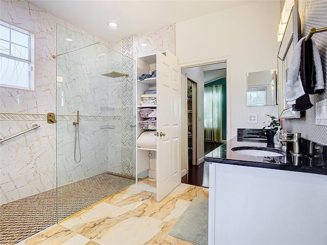 bathroom with vanity and a tile shower