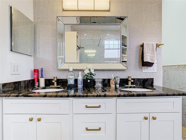 bathroom featuring tasteful backsplash, a shower, and vanity