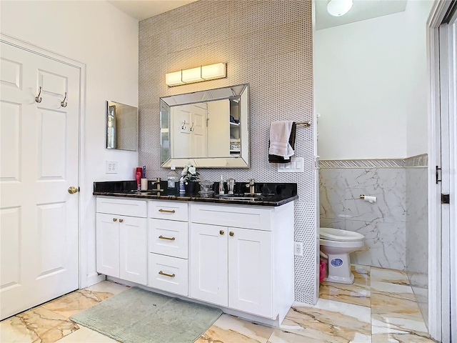 bathroom with vanity and tile walls