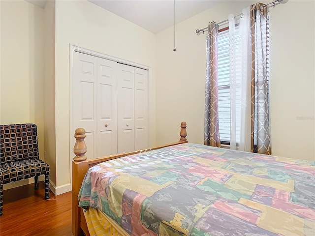 bedroom featuring hardwood / wood-style floors and a closet