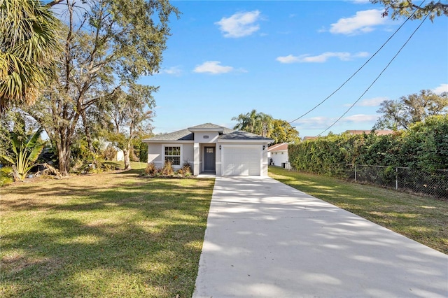 view of front of property with a front yard and a garage