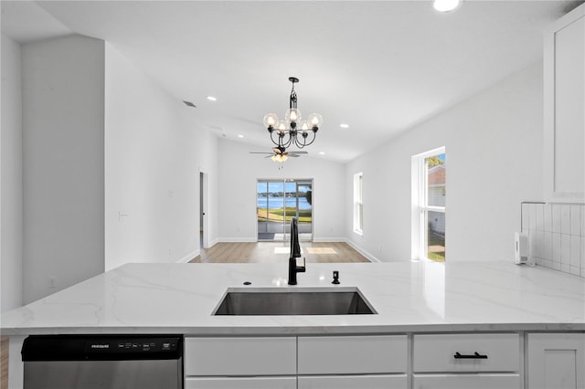 kitchen featuring dishwasher, white cabinets, a healthy amount of sunlight, and sink