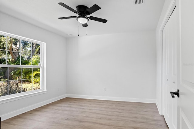 empty room with light hardwood / wood-style flooring and ceiling fan