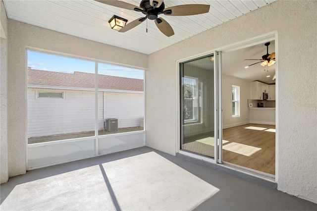 unfurnished sunroom with ceiling fan and wood ceiling