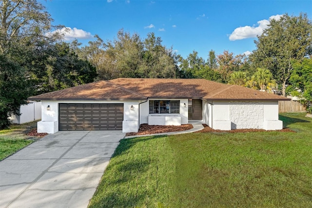 ranch-style house featuring a garage and a front lawn