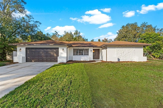 ranch-style house with a front yard and a garage