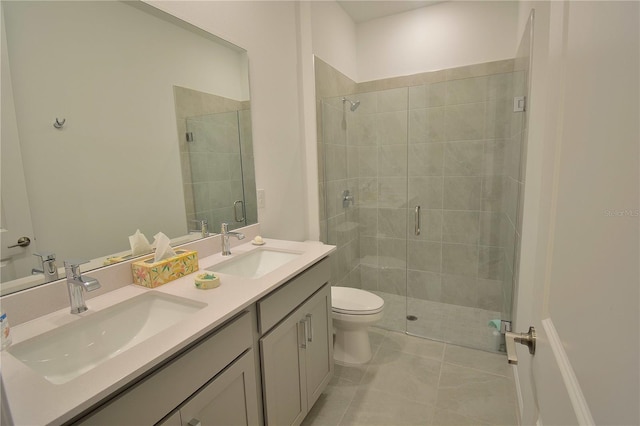 bathroom with tile patterned flooring, vanity, toilet, and an enclosed shower