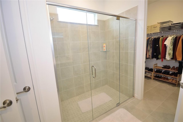 bathroom featuring tile patterned flooring and an enclosed shower