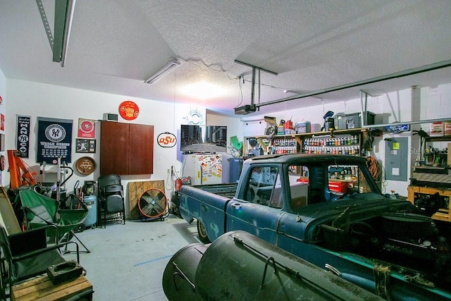 garage featuring electric panel and a garage door opener