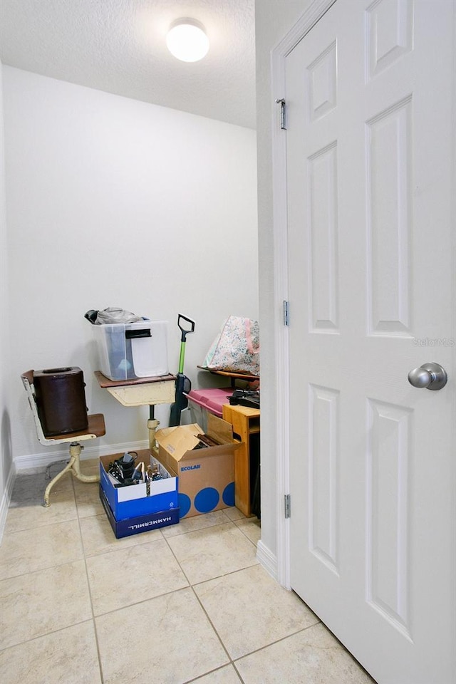 interior space with tile patterned floors and a textured ceiling