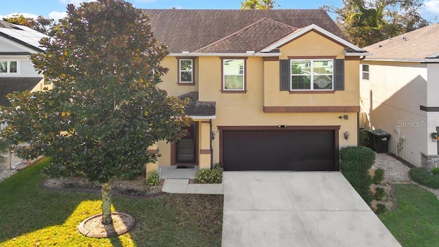 view of front facade featuring a front yard and a garage