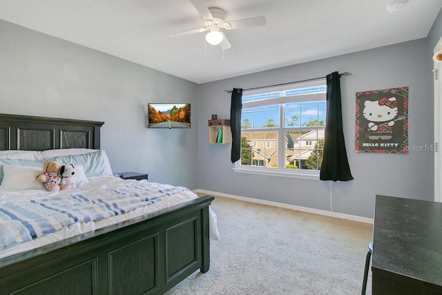 bedroom with ceiling fan and light colored carpet