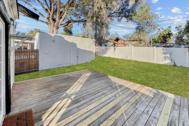 wooden terrace featuring a lawn