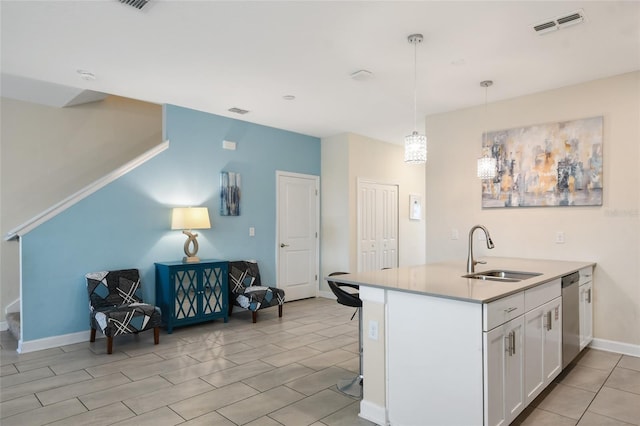 kitchen with kitchen peninsula, white cabinetry, sink, and hanging light fixtures