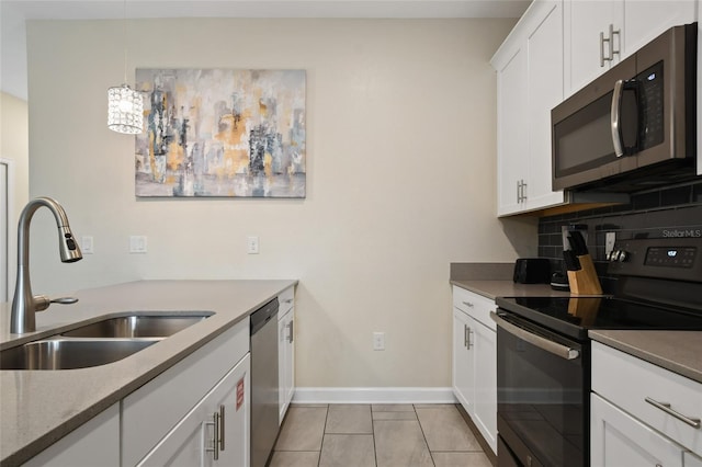 kitchen with white cabinetry, sink, stainless steel appliances, tasteful backsplash, and light tile patterned floors