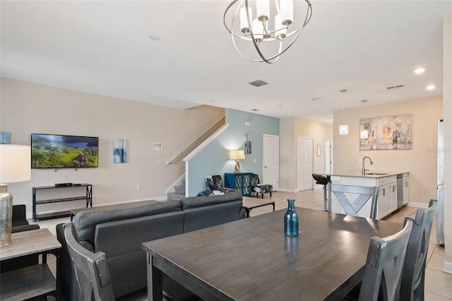 dining area with sink, light tile patterned floors, and a notable chandelier