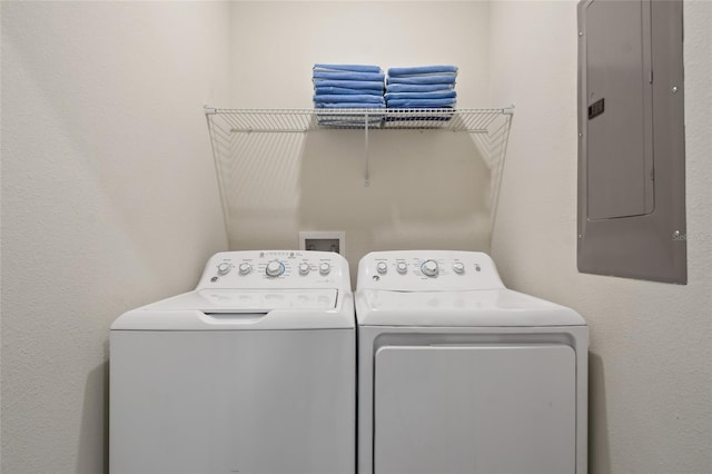 laundry area featuring electric panel and washing machine and clothes dryer