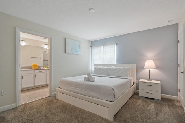 carpeted bedroom featuring ensuite bath