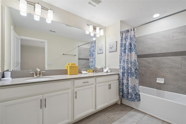 bathroom with tile patterned flooring, vanity, and shower / bath combo with shower curtain