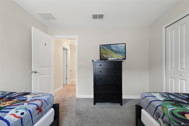 carpeted bedroom featuring a closet