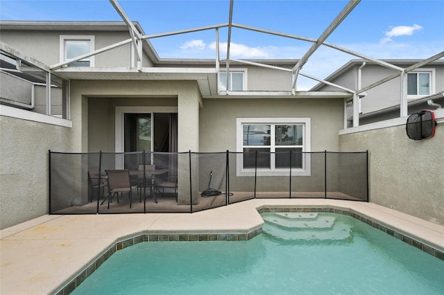 rear view of property with a lanai and a patio