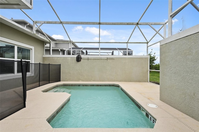 view of swimming pool with a lanai and a patio