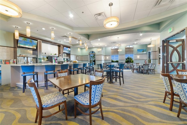 dining area featuring light carpet