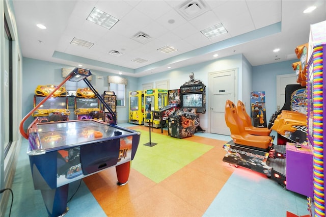 recreation room with a tray ceiling