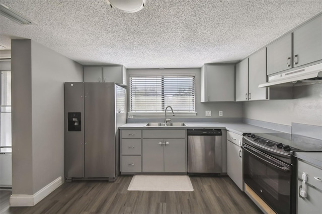 kitchen with stainless steel appliances, gray cabinetry, dark hardwood / wood-style flooring, and sink