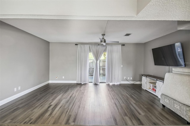 unfurnished living room with ceiling fan and dark hardwood / wood-style floors