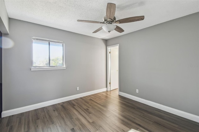 empty room featuring a textured ceiling, ceiling fan, and dark hardwood / wood-style flooring