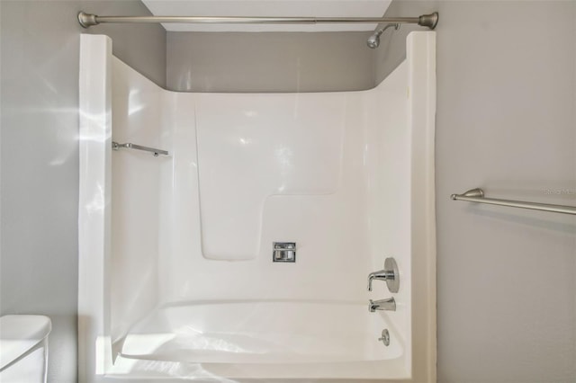 bathroom featuring toilet and shower / bath combination