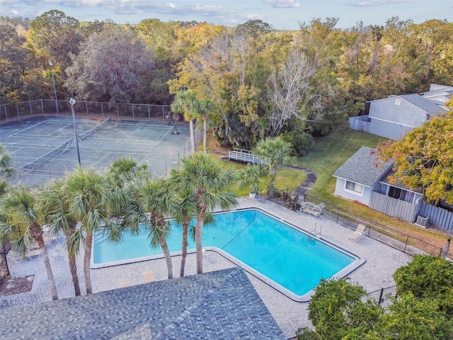 view of swimming pool featuring tennis court